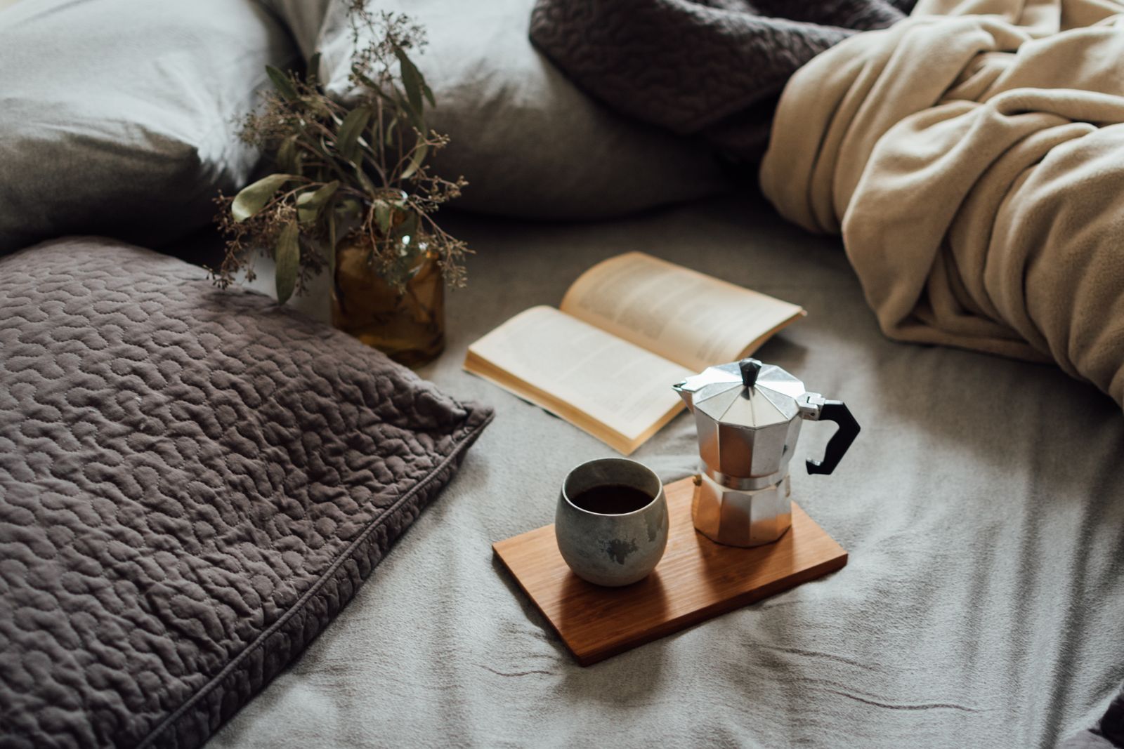 Sample image of a warm bed with a book and a cup of coffee on a tray